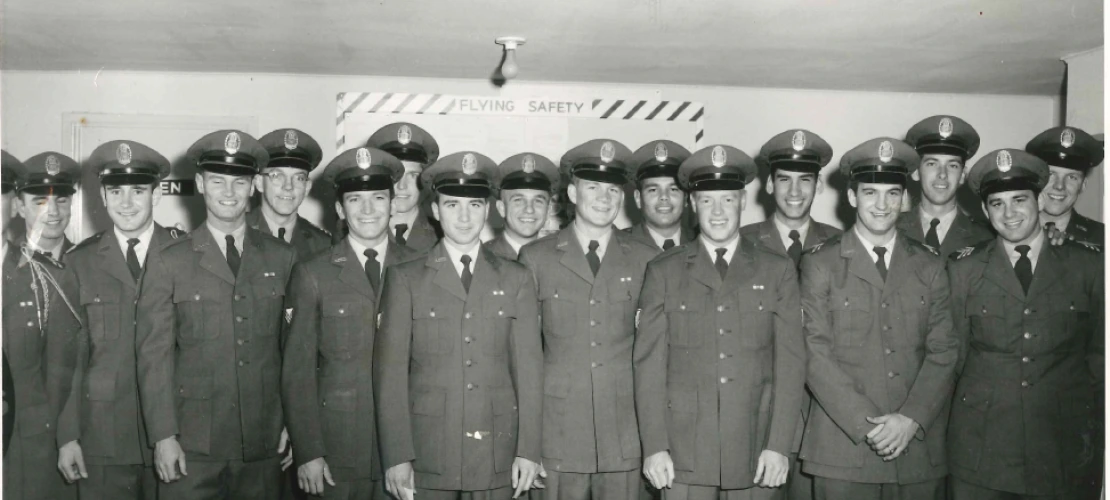 black and white photo of man standing in uniform